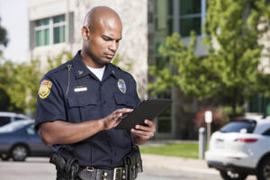 police officer holding tablet