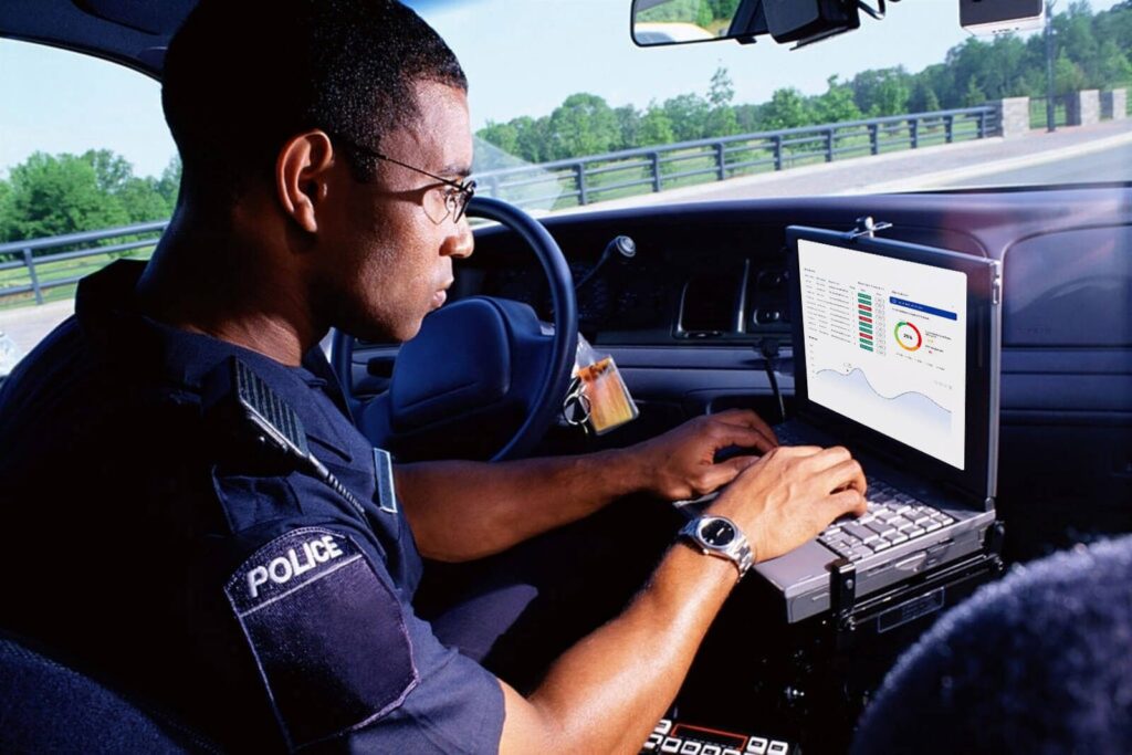 police officer working on a laptop