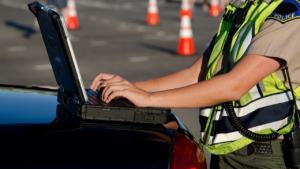 female police officer on computer government form officer survey